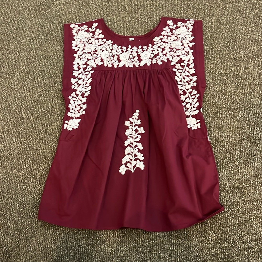 Maroon blouse with white stitching